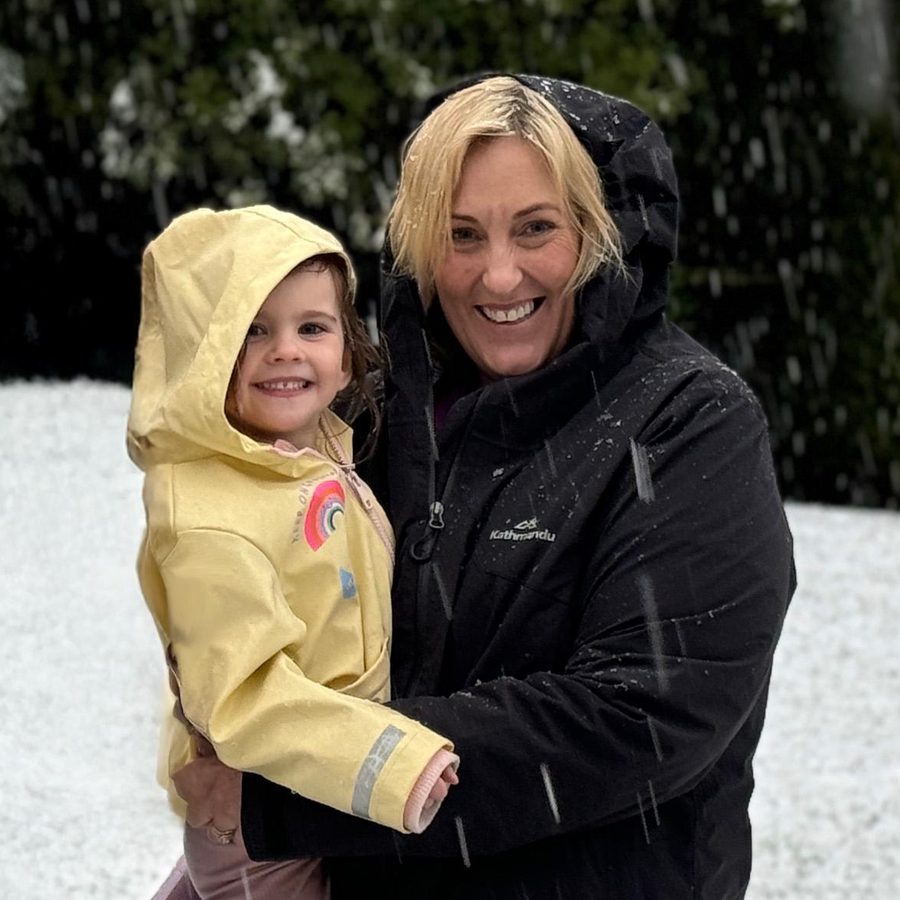 Jen holding her granddaughter in the snow